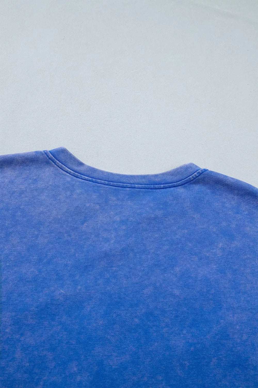 Blue cotton t-shirt with washed effect and notched neckline detail