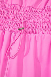 Fuchsia pink active romper set with ruched waistband and drawstring detail.