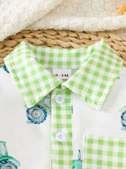 Baby one-piece with tractor print, green gingham collar and trim, and white buttons.
