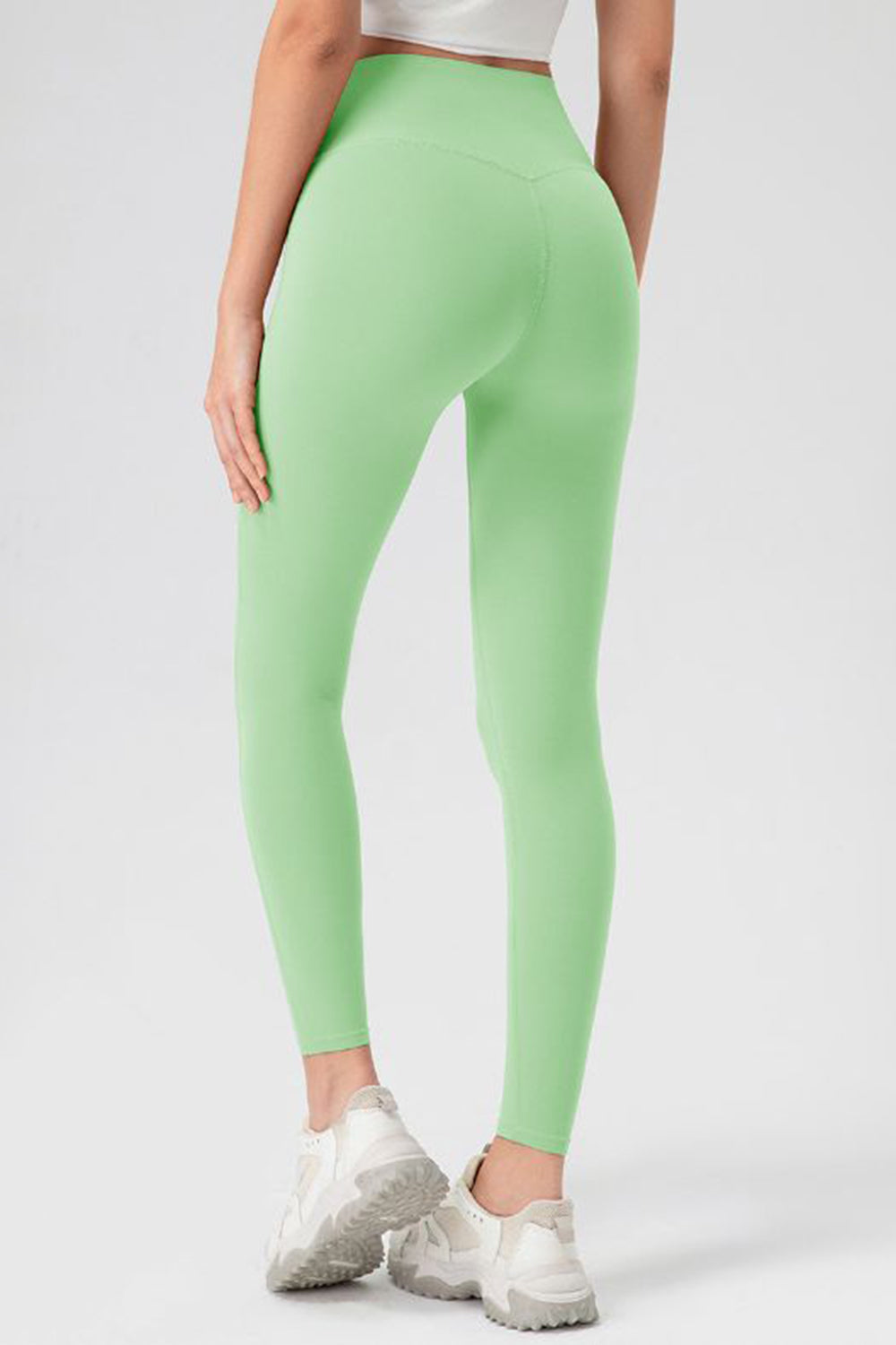 Matcha green high-waist performance leggings with sculpting seam detail.