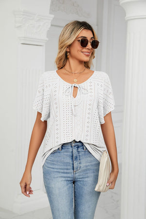 White eyelet tie-neck blouse with flutter sleeves and a breathable casual fit.