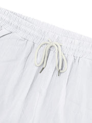 White cargo sweatpants with drawstring waist and metal-tipped cords.