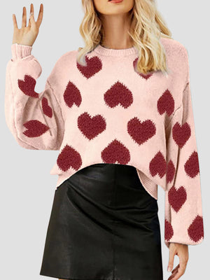 Watermelon pink knit sweater with allover heart motif and balloon sleeves.
