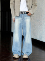 Men's light blue wide leg jeans with faded detailing and a belted waist.