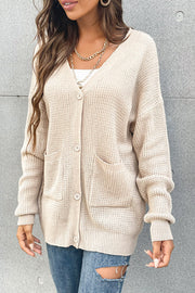 Beige waffle knit pocket cardigan with V-neck and button front.