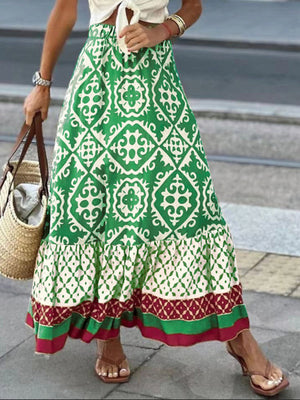 Tiered maxi skirt in green with medallion print, ruffle hem, and contrasting border details.