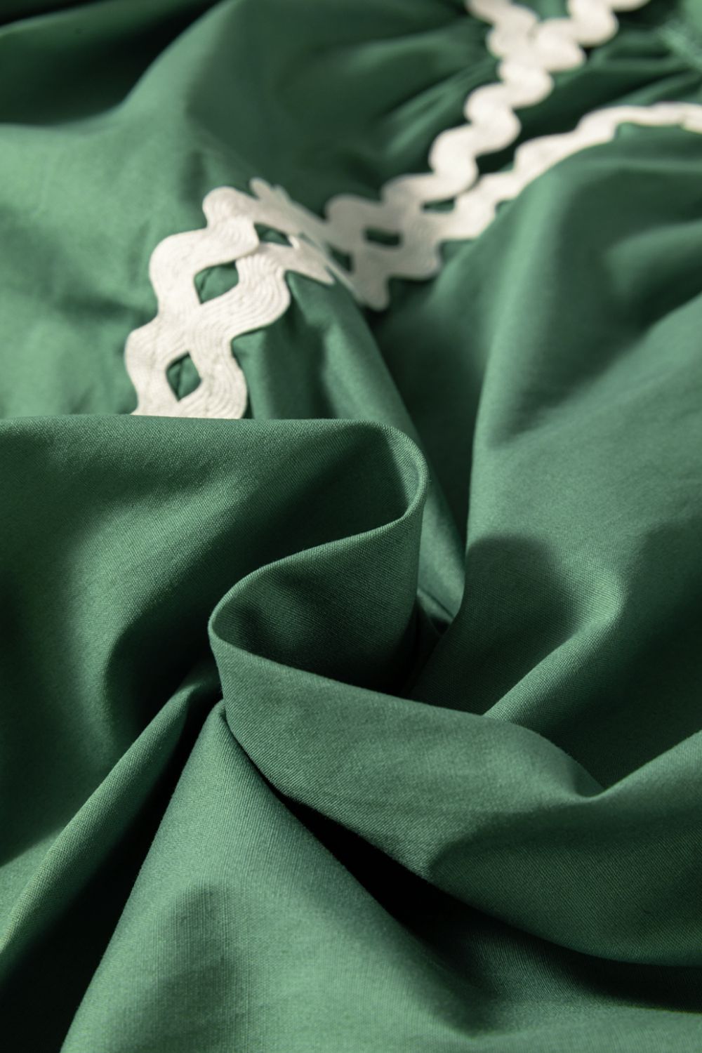 Moss green blouse with white scalloped trim detail