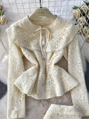 Luxe lace peplum top with bow neck and jeweled buttons, cream color.