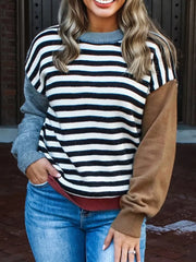Colorblock striped knit sweater with crew neck and contrasting sleeves.