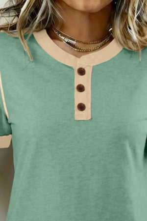 Cotton short sleeve henley blouse in green with beige trim and three buttons.