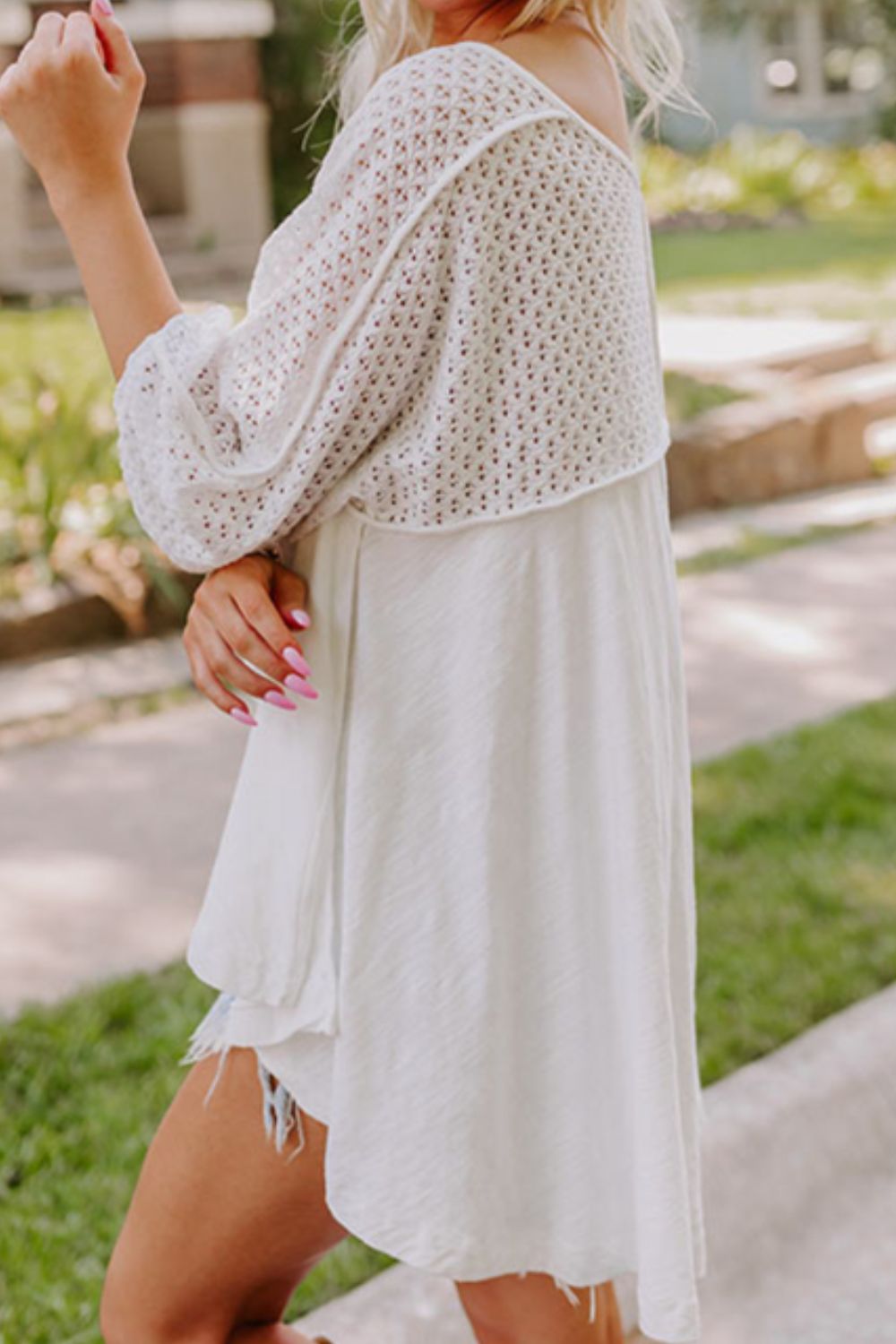White lace-inset dolman sleeve blouse with a relaxed fit.