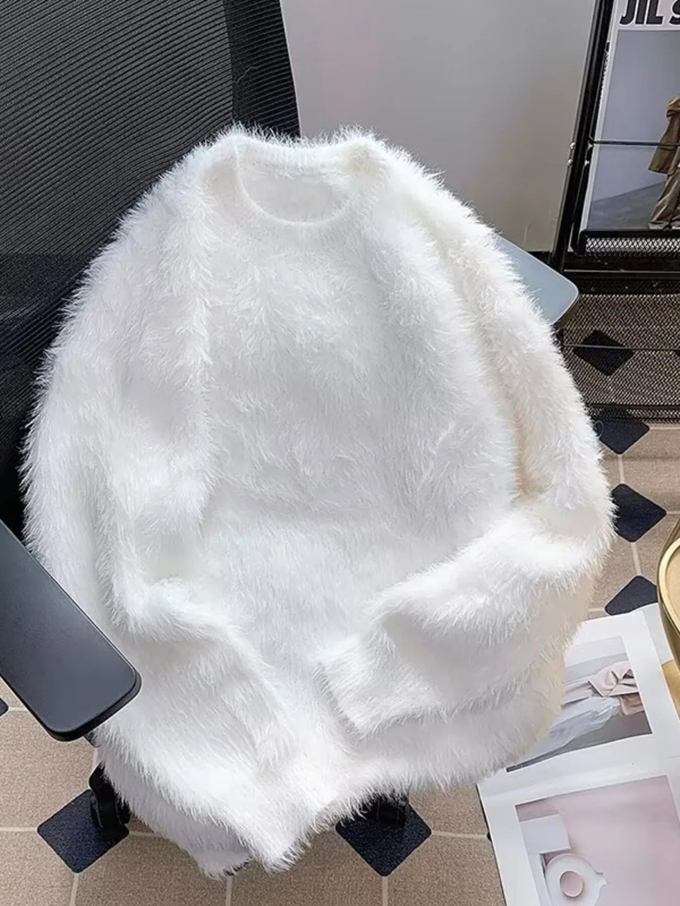 White fluffy knit pullover sweater with crew neck and long sleeves.