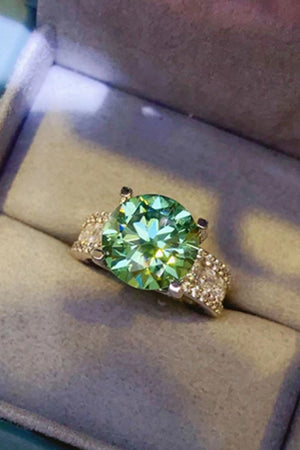 Light green moissanite pavé band ring with a large center stone.