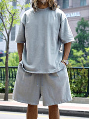 Men's light gray relaxed fit two-piece set with drawstring shorts and crew neck t-shirt.