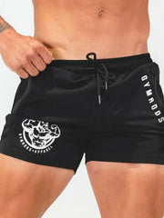 Black athletic shorts with drawstring, zipper pockets, and graphic logo detail.