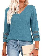 Blue 3/4 sleeve t-shirt with V-neck and cutout detail on sleeves.