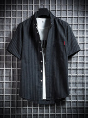 Men's black striped short sleeve button-up shirt with a pocket detail.