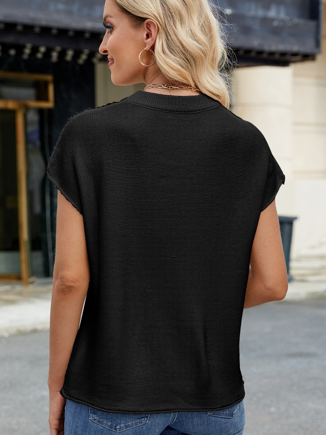 Black knit cap sleeve top with vertical seam detail.