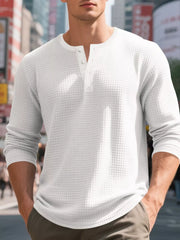 White waffle knit henley t-shirt with button placket and long sleeves.