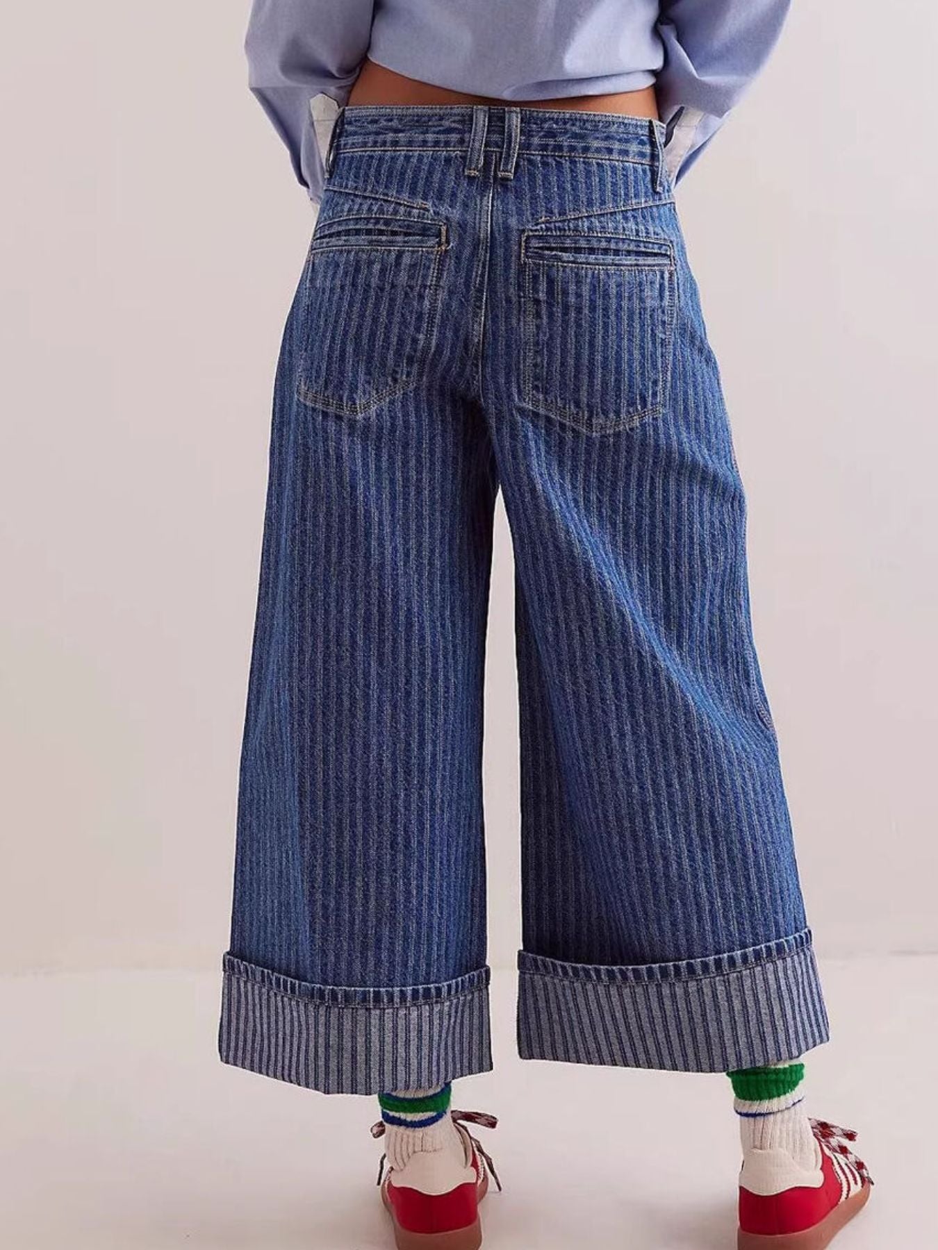 Dark blue striped high-waisted cropped jeans with cuffed hems.