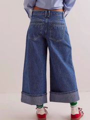Dark blue striped high-waisted cropped jeans with cuffed hems.