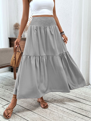 Gray ruffled smocked waist maxi skirt with tiered hem detail.