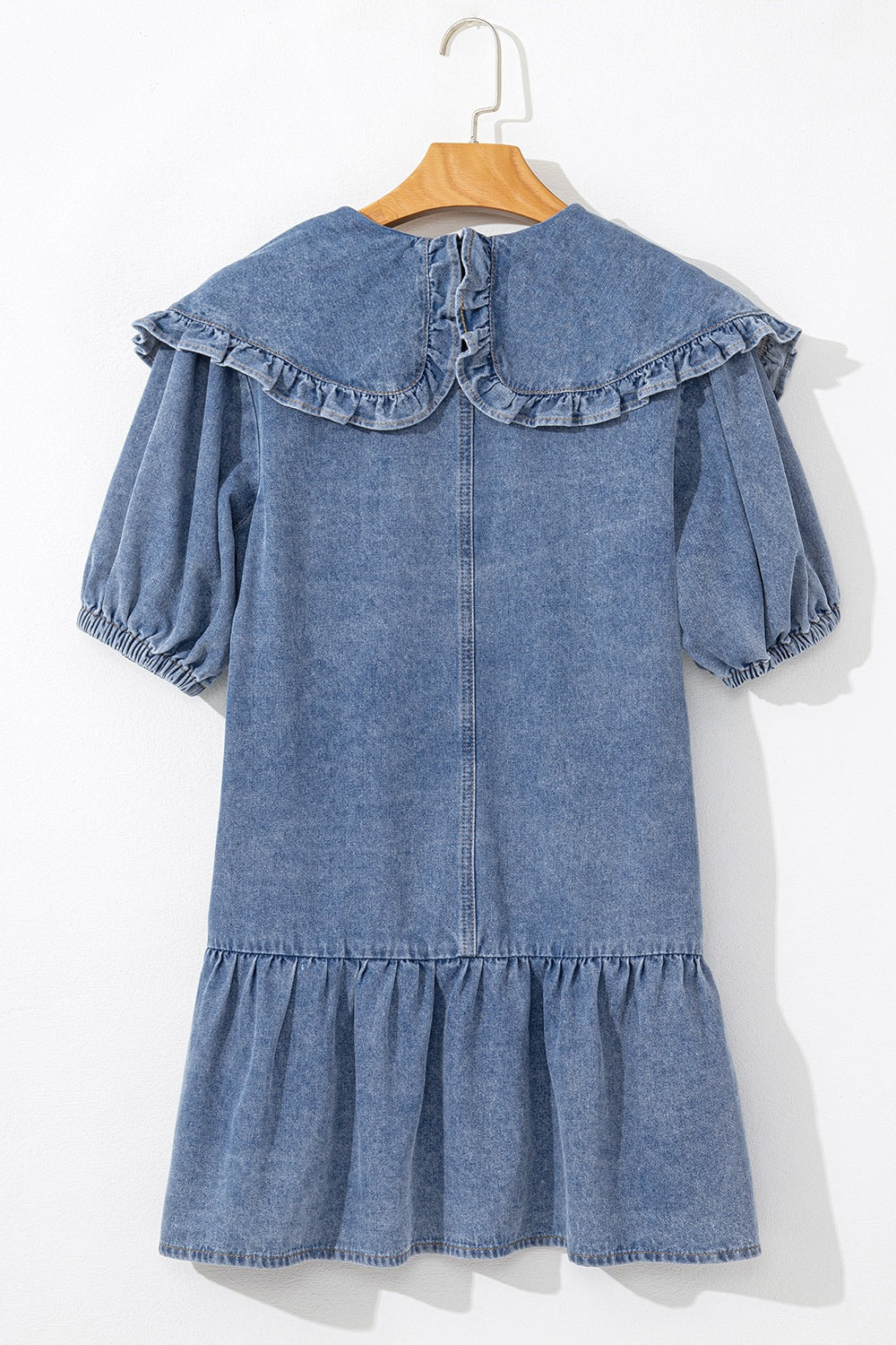 Denim mini dress in medium wash with a ruffled collar, puff sleeves, and tiered ruffle hem.