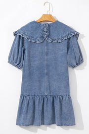 Denim mini dress in medium wash with a ruffled collar, puff sleeves, and tiered ruffle hem.