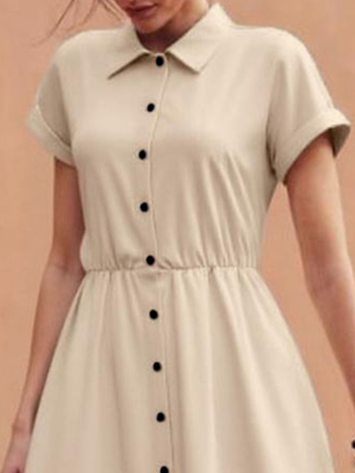 Beige button-down midi shirt dress with cinched waist and short sleeves.