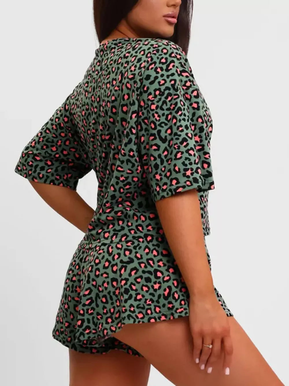 Green leopard print pajama set with pink accents, featuring a relaxed fit t-shirt and shorts.