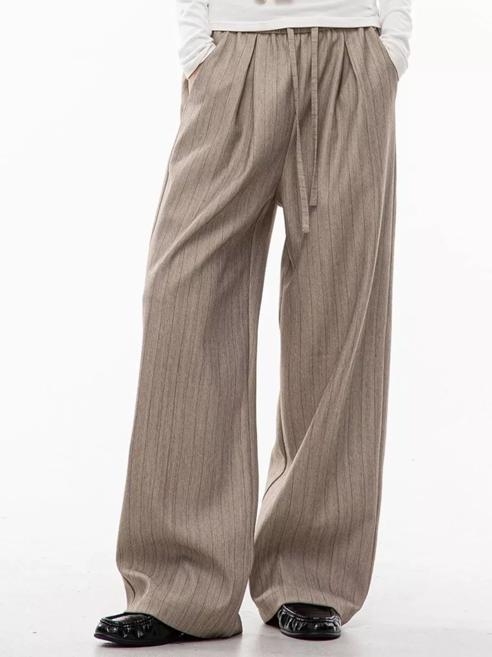 Khaki wide-leg pleated trousers with vertical pinstripes and drawstring waist.