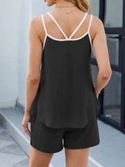 Black ribbed loungewear set with white contrast trim cami and shorts.