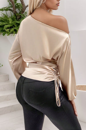 Tan satin blouse with asymmetric neckline and ruched side detail