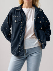 Black corduroy studded overshirt with relaxed fit and collar, buttoned front.