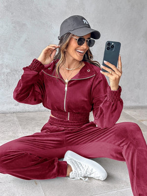 Burgundy velvet crop tracksuit with zipper detail and cinched waist.