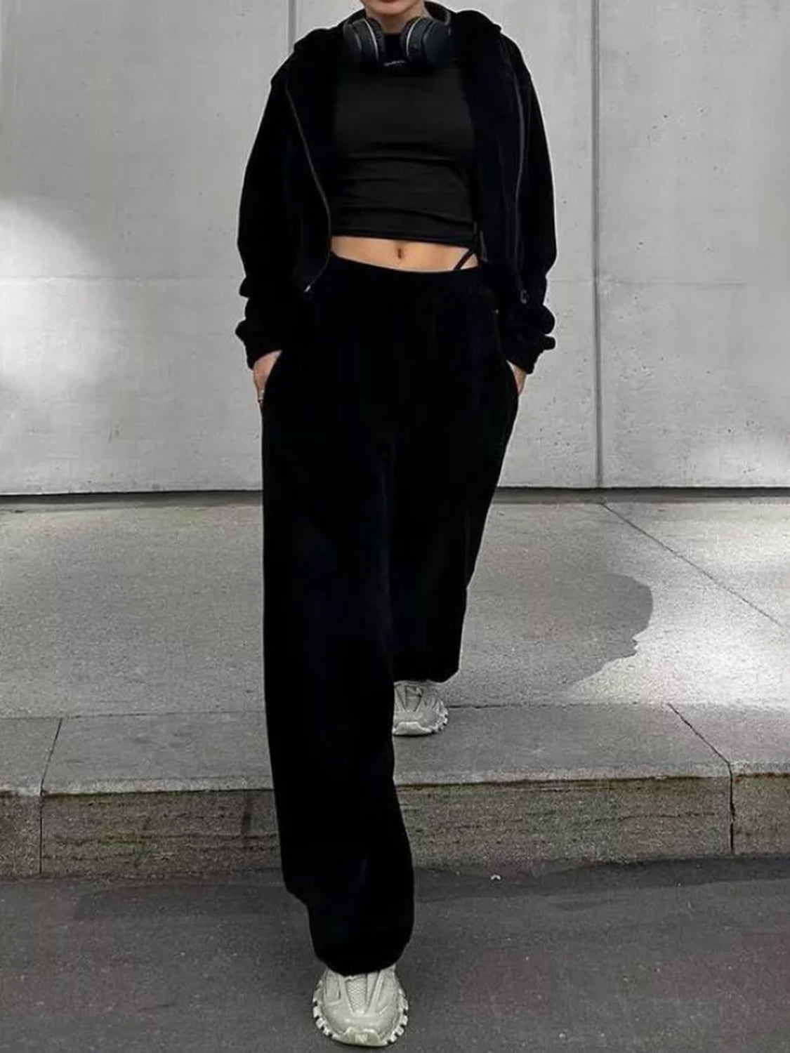 Black cropped zip hoodie and wide leg pants set with a black crop top.
