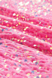 Fuchsia pink sweatshirt with allover iridescent sequins and textured fabric detail.