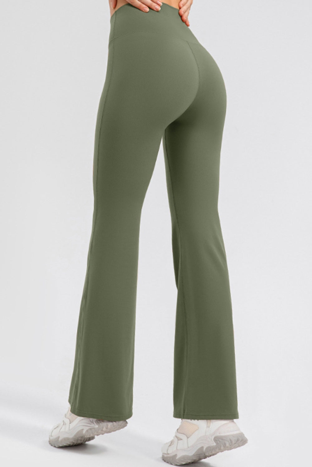 Matcha green flared leggings with a high waist, shown from the back.