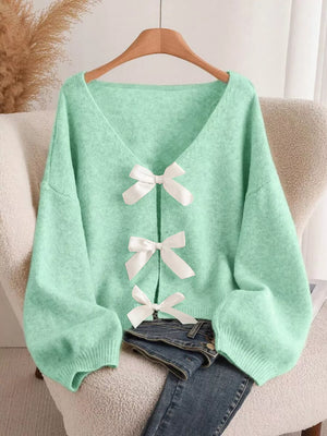 Green V-neck cardigan with balloon sleeves and three white bow-knot details.