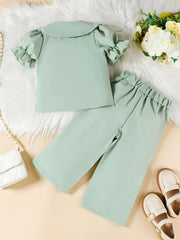 Green toddler set with ruffle trim puff sleeves and wide leg pants.