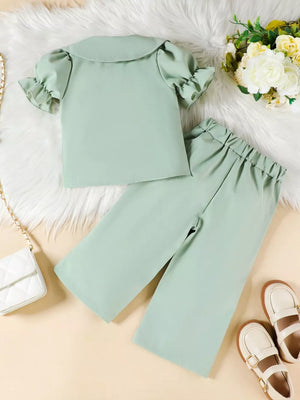 Green toddler set with ruffle trim puff sleeves and wide leg pants.