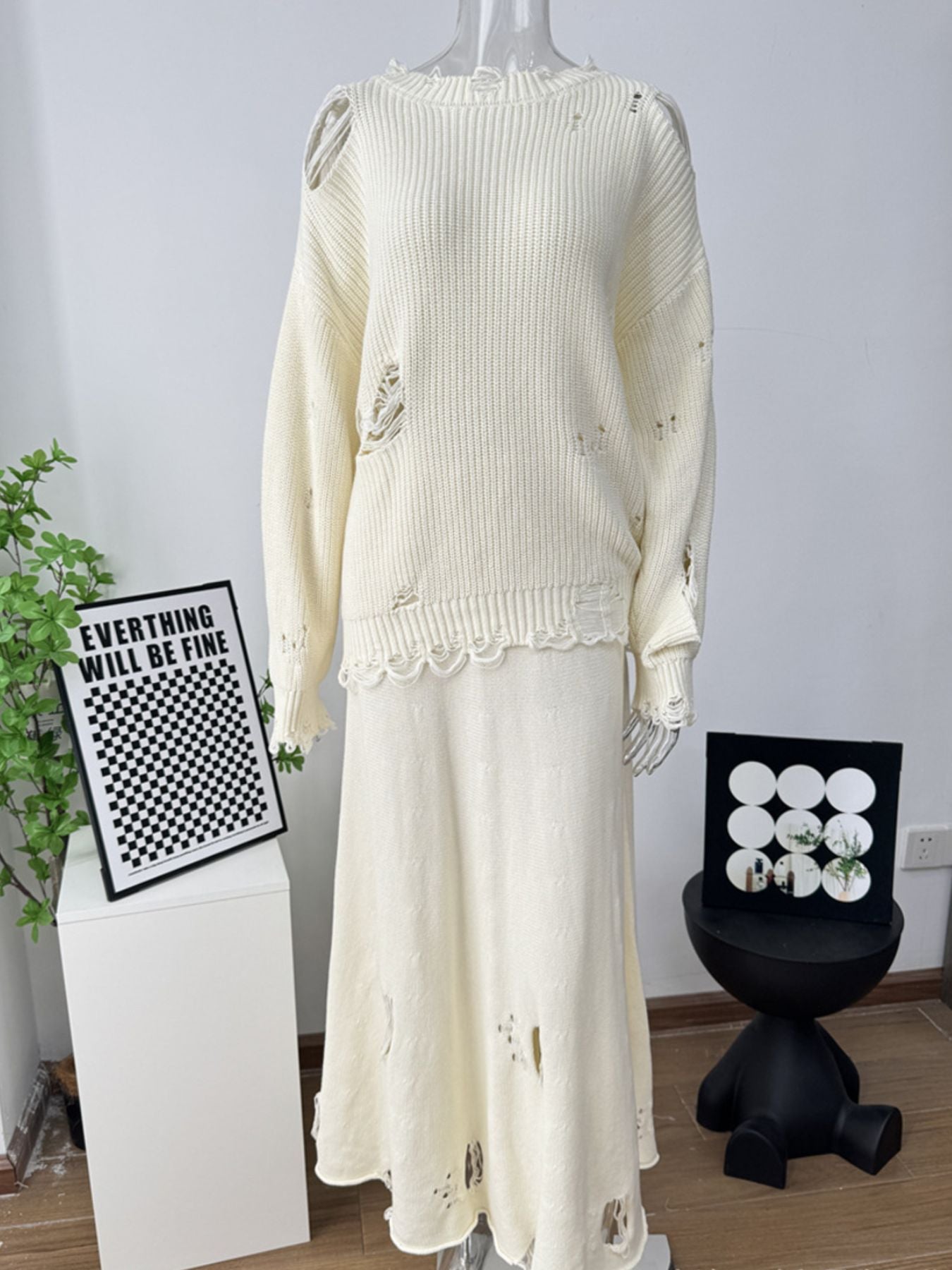Distressed off white cotton sweater set with deconstructed details and a scalloped hem skirt.