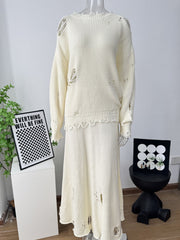 Distressed off white cotton sweater set with deconstructed details and a scalloped hem skirt.