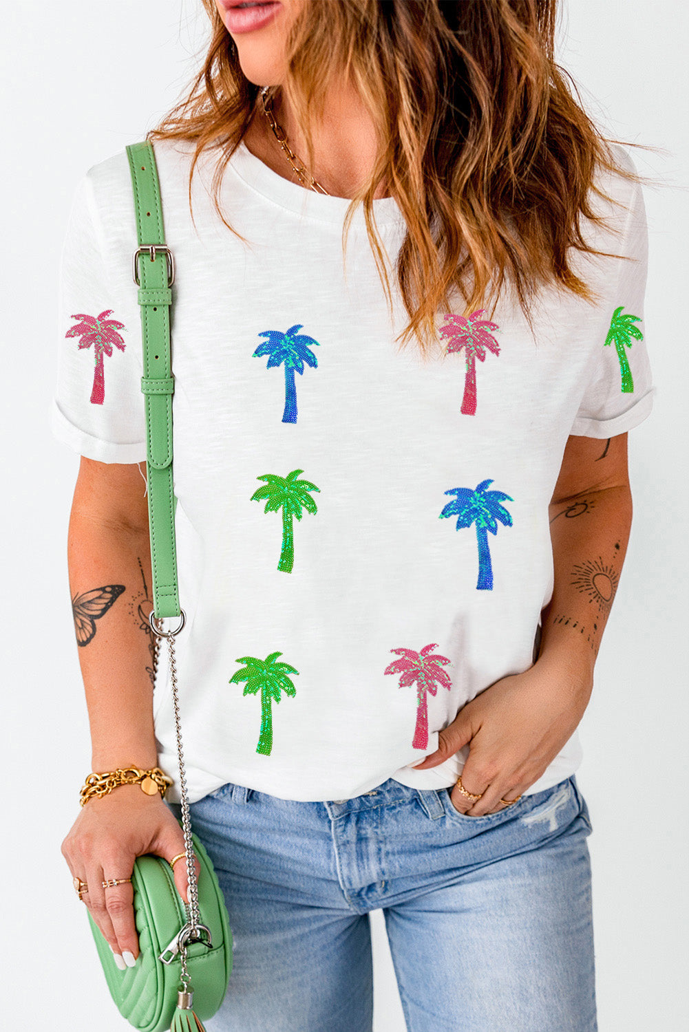 White crewneck tee with glitter palm tree print in pink, blue, and green.