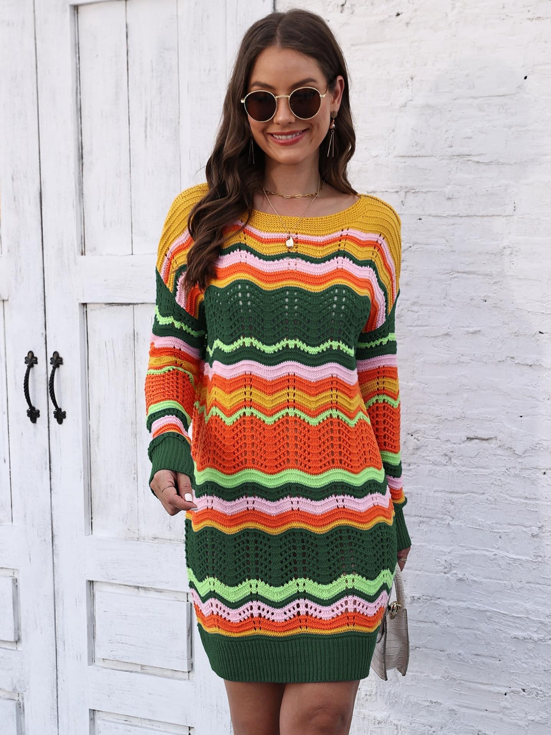Chevron stripe knit mini dress with crochet detail in orange, green, yellow, and pink.