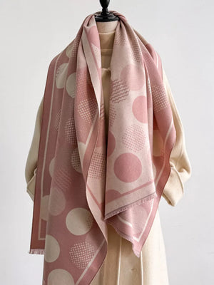 Dusty pink polka dot textured scarf with fringe and geometric patterns.