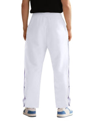 White men's track pants with snap buttons down the sides.