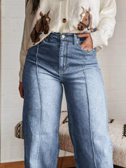 Light blue denim wide-leg jeans with buttoned pockets and front seam detail.