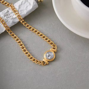 Gold curb chain necklace with vintage coin charm detail