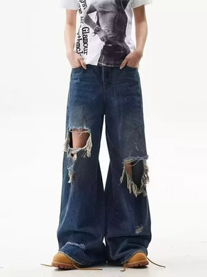 Men's distressed wide-leg jeans in dark wash denim with large ripped knee details.